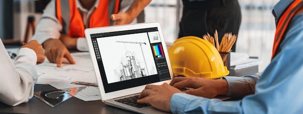 engineer and architect working together brainstorming and designing blueprint using laptop working with architectural software for precise digital interior or structure design insight