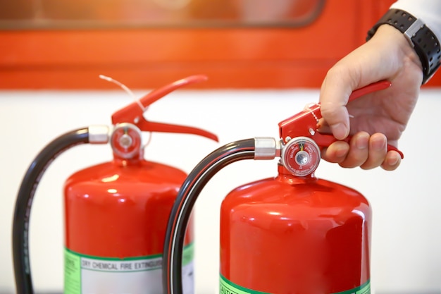 Engineer are  checking handle a fire extinguishers tank.