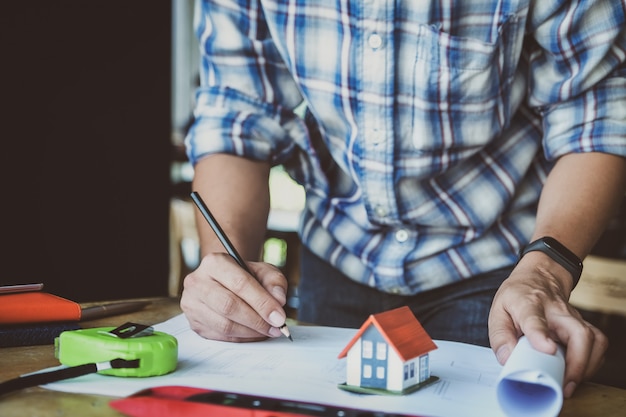 Engineer are planning to drawing house structure on Blueprint for his customers.