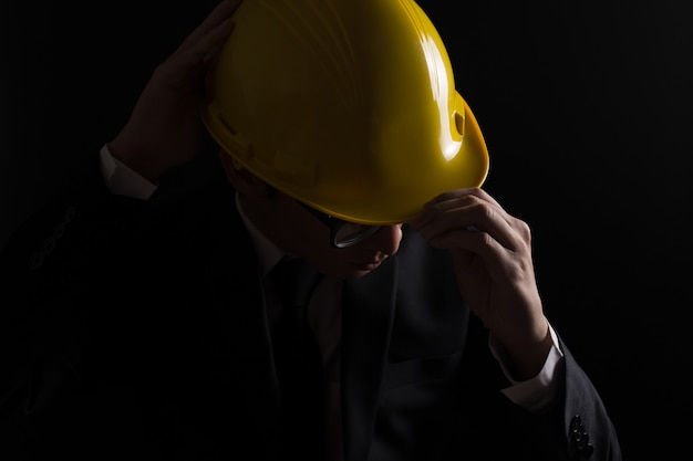 Engineer in black suit on isolated black background