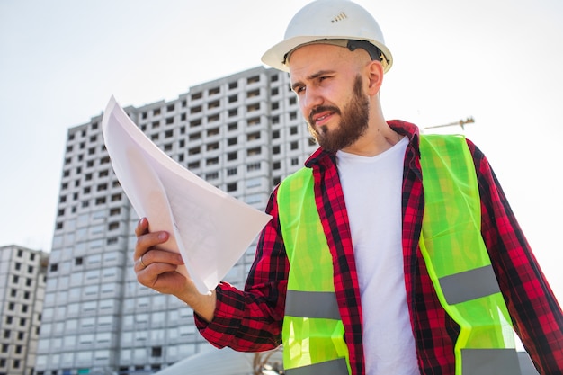 Engineer checking construction site plans