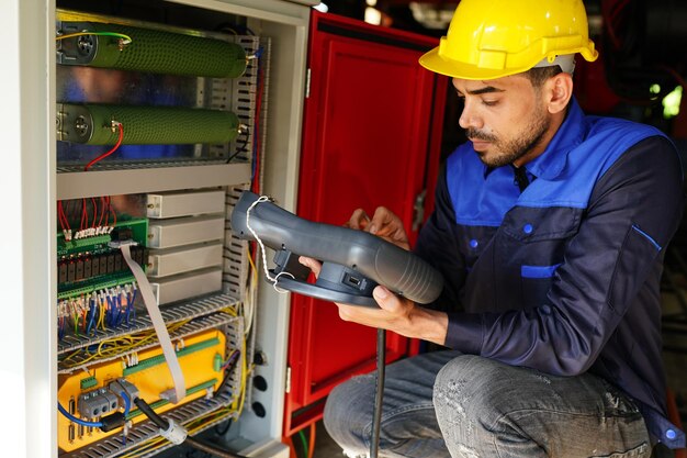 Engineer checking control panel and teaching new Automatics robot arm and operating control machine in factory