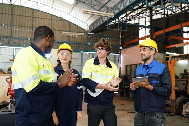 Engineer checking control panel and teaching new Automatics robot arm and operating control machine in factory