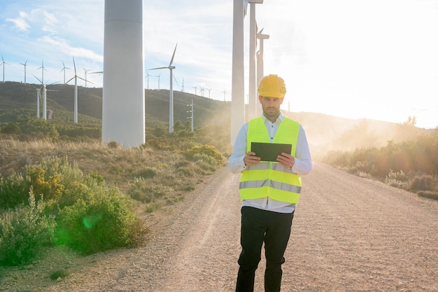 Engineer checking wind turbine energy with a tablet