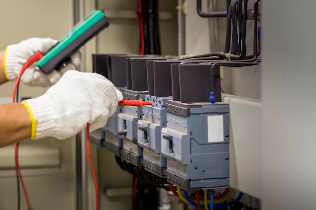 Engineer checks the operation of electrical control equipment, maintenance concept.