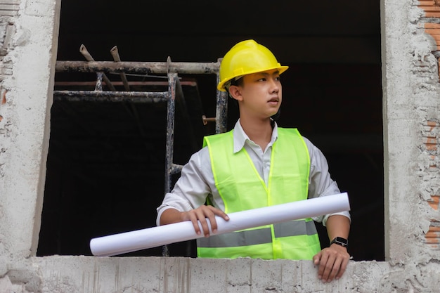 Engineer concept The building schemer viewing some details of the construction