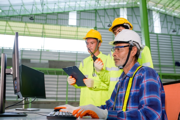 Engineer and construction workers wearing a safety helmet