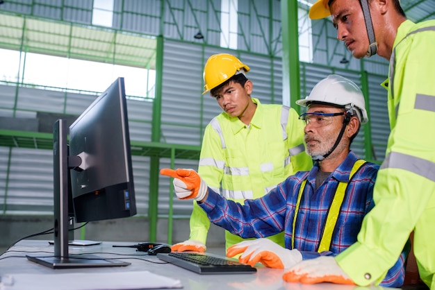 Engineer and construction workers wearing safety helmets