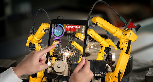 Photo engineer controls robotic arms by augmented reality industry technology