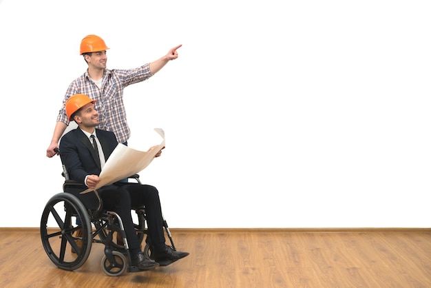 The engineer and disabled gesture on the white wall background