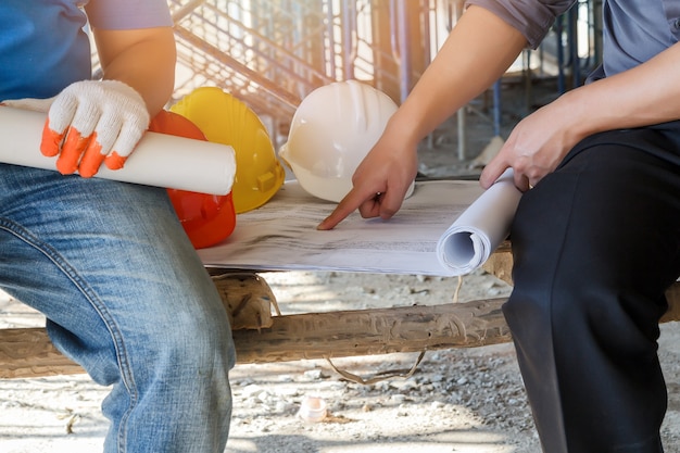 Engineer discussing with foreman about project in building construction site