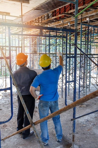 Foto ingegnere che discute con il caporeparto circa il progetto nel cantiere