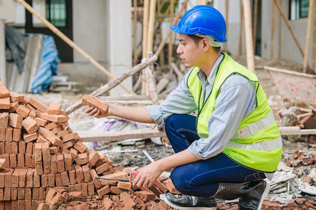 Engineer foreman manager quality check Burnt Clay Bricks for good construction building project