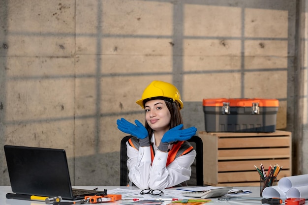 Engineer in helmet and vest civil worker smart young cute brunette girl with hands on face