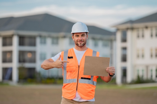 Engineer hold paper board for text builder showing signboard placard banner poster serious engineer