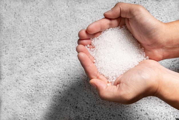 Engineer hold white plastic on hand polymer petrochemical product as polymer raw material for plastic in polymer chemical industry design and test in polymer science laboratory