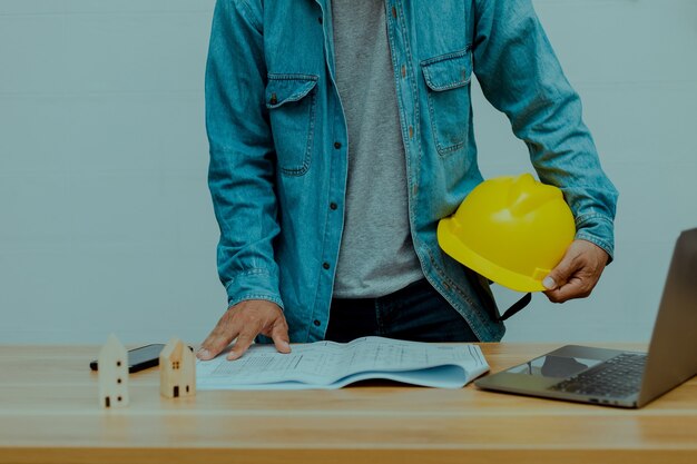 An engineer holding a construction helmet