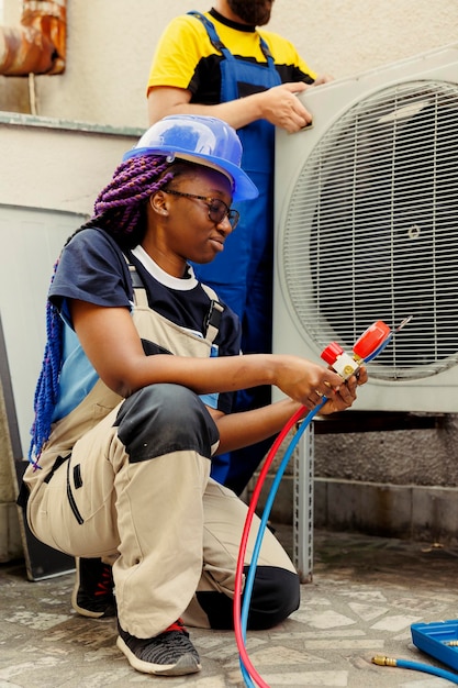 Photo engineer holding freon manifold gauges