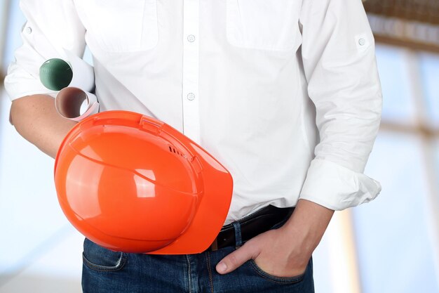 Engineer holding orange helmet for workers security