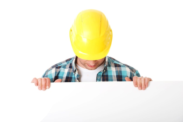 Engineer holding placard against white background