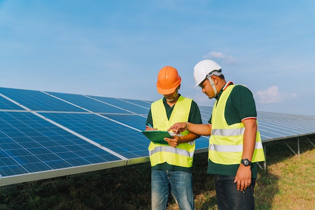 Photo engineer inspect solar panel  at solar power plant