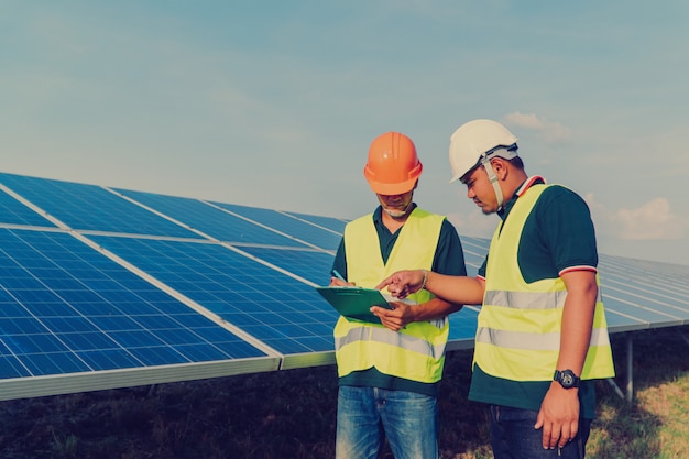 Photo engineer inspect solar panel  at solar power plant