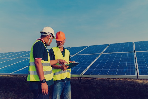 Photo engineer inspect solar panel  at solar power plant