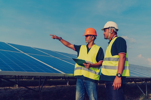 Photo engineer inspect solar panel  at solar power plant