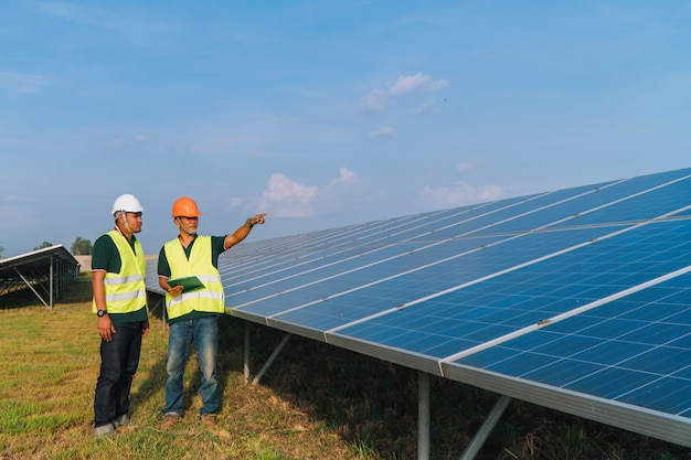 Photo engineer inspect solar panel  at solar power plant