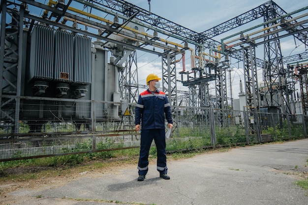 Engineer inspecting the equipment of the substation