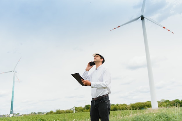 Engineer inspecting Project Manager at the Wind Farm. Man working in the enviromental