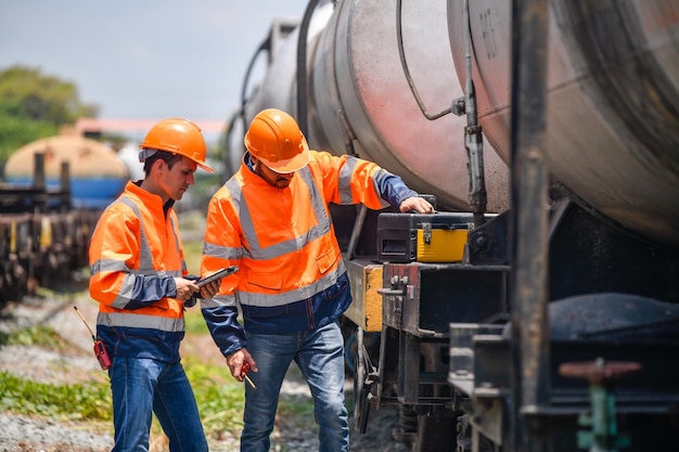 Engineer under inspection and checking construction process railway and checking work on railroad station Engineer wearing safety uniform and safety helmet in work