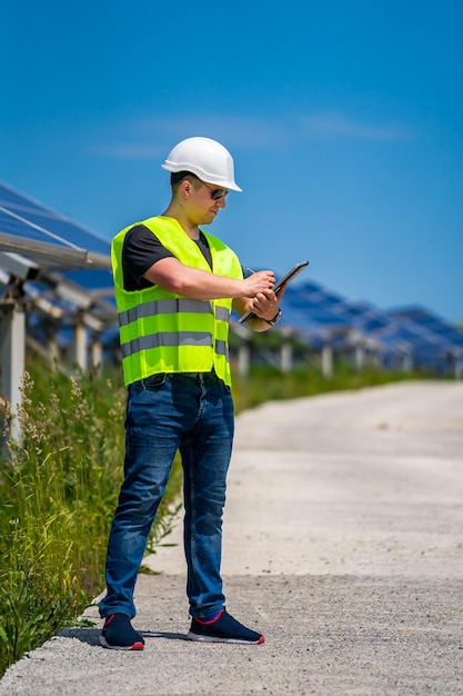 Engineer is checking installed solar panels at solar energy plant