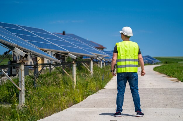 Engineer is looking out at new energy base of solar system pannels.