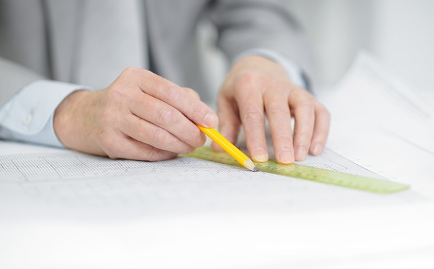 engineer is making the drawing sitting behind his Desk