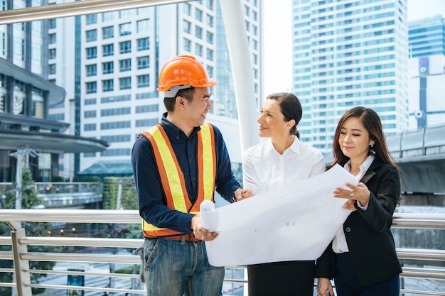 The engineer is presenting the blueprint to the boss lady