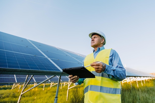 Engineer man working at alternative energy farm alternative eco energy concept high quality photo