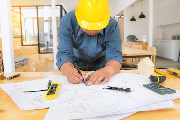 Engineer man working with drawings inspection in workplace 