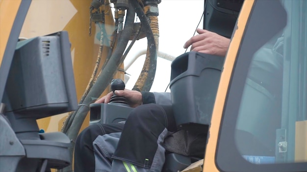 Engineer operator crane in action clip man in cabin controls the crane he sit a top in crane cabin