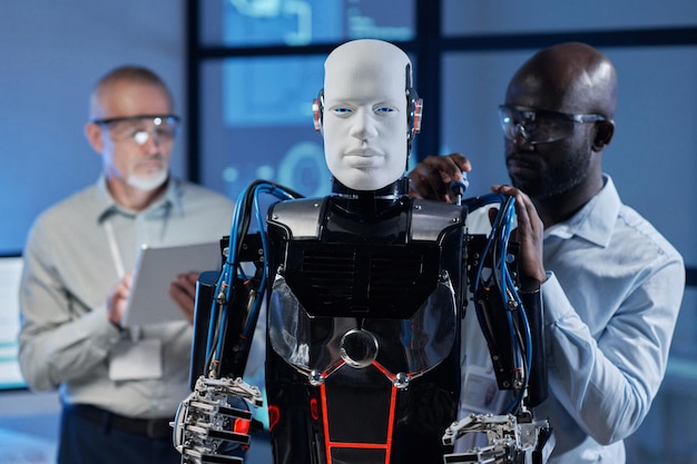 Engineer repairing robot with tools