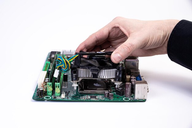 Engineer repairman holding hands in black gloves chip processor CPU to insert into the socket of the computer motherboard The concept of technology hardware in the neon light