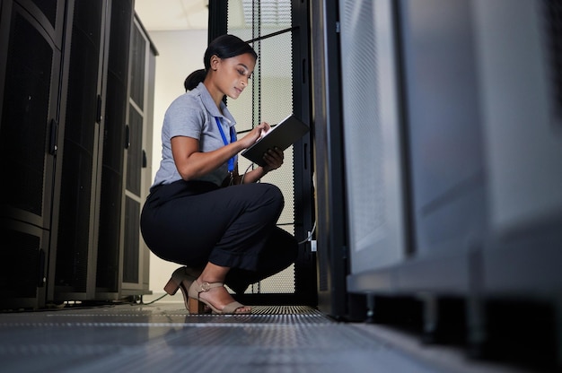 engineer server room and woman with tablet for database connection cable maintenance or software update at night cybersecurity it and female coder with technology for networking in data center