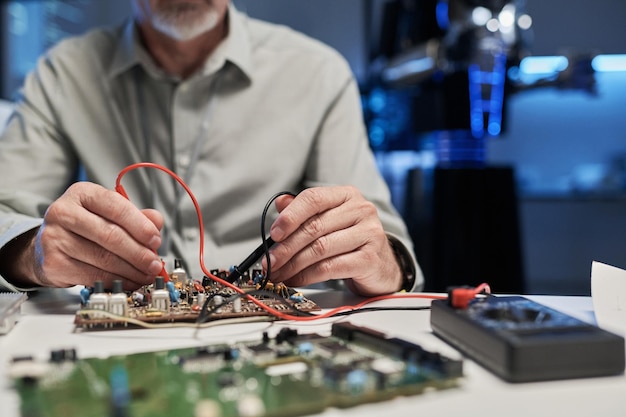 Engineer soldering motherboard with tool