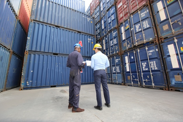 Engineer or supervisor checking and control loading Containers box from Cargo at harbor