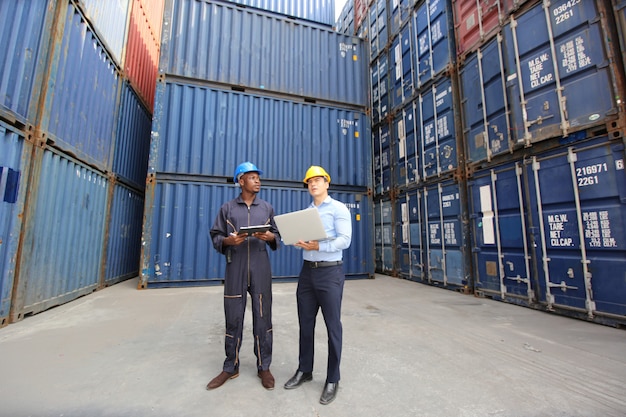 Engineer or supervisor checking and control loading Containers box from Cargo at harbor.