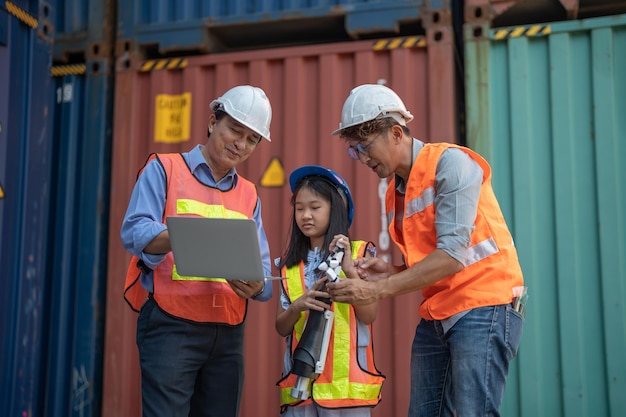 Engineer Teachers teaching a girl about robot hand In Science Robotics Or Engineering Class