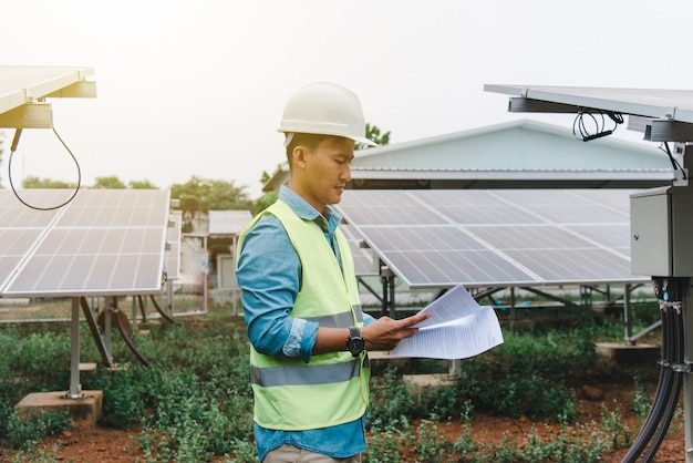 Photo engineer technician checking and operating system of solar cell farm power plant solar station