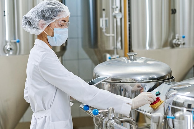 Foto ingegnere in uniforme che controlla i macchinari