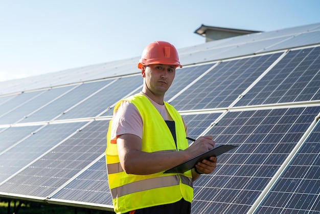 Engineer in uniform working of solar power plant Solar station development concept