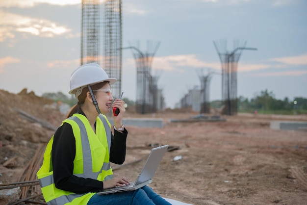 Engineer woman working at site of bridge under construction